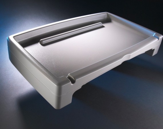 A twin sheet thermoformed tray with walls to prevent spilling.